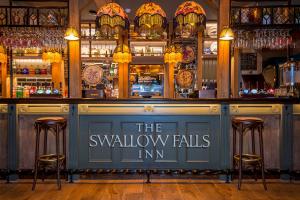 a bar with the swallow falls inn sign on it at The Swallow Falls Inn - The Inn Collection Group in Betws-y-coed