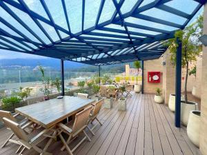 a patio with a wooden table and chairs on a deck at Loft en el corazón de Bgtá, Centro Internacional in Bogotá