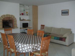 a living room with a table and chairs and a couch at Ty Dahouet Bretagne in Pléneuf-Val-André