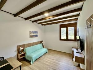 a bedroom with a bed and a desk and a window at Villa El Guanche -Boutique Apartments & rooms in Gáldar