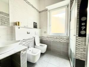 a white bathroom with a sink and a toilet at Casa Miró in Arona