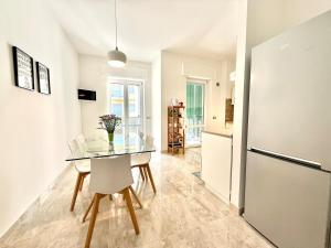 a dining room with a glass table and a refrigerator at Casa Miró in Arona +18 photos