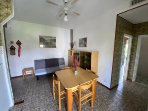 a living room with a table and a couch at Appartamento Gina lido di savio in Lido di Savio