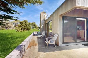 a house with a patio with two chairs and a table at Whale Tales in Gualala