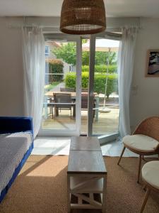 a living room with a bed and a table at Maison 3 piscines - Résidence 3 étoiles in Pornichet