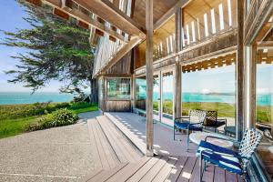a porch of a house with a view of the ocean at Curtis-Moulton Retreat in Sea Ranch