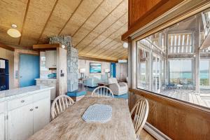 a kitchen and dining room with a table and chairs at Curtis-Moulton Retreat in Sea Ranch
