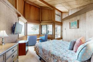 a bedroom with a bed and a desk and a television at Curtis-Moulton Retreat in Sea Ranch +23 photos