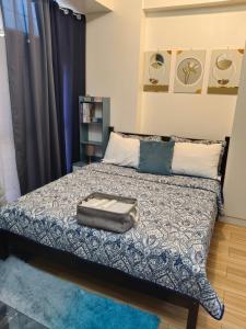 a bedroom with a bed with a suitcase on it at Tessa's Place Staycation in Biñan +26 photos