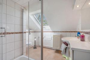 a bathroom with a shower and a sink at Ferienwohnung 'am Park' in Rabenkirchen-Faulück +20 photos