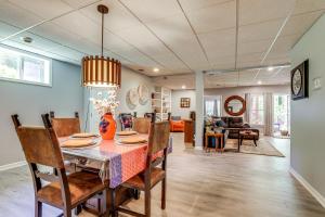 a dining room and living room with a table and chairs at Spacious Yard and BBQ Chic Escape in Lawrenceville! in Lawrenceville