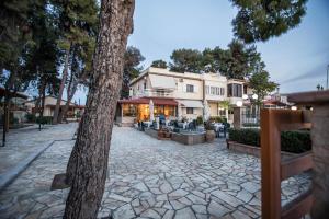 a cobblestone street in front of a building at Vasilios Marinos Rooms in Korinthos