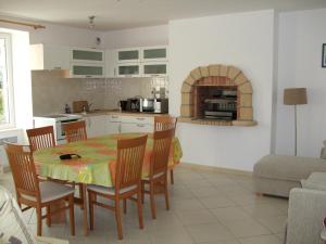 a kitchen and dining room with a table and chairs at Ty Dahouet Bretagne in Pléneuf-Val-André