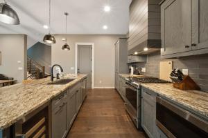 a large kitchen with wooden floors and stainless steel appliances at Majestic Meadows in Boone