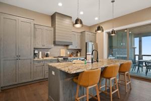 a kitchen with a large island with bar stools at Majestic Meadows in Boone