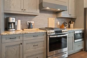 a kitchen with white cabinets and a stove top oven at Majestic Meadows in Boone +45 photos
