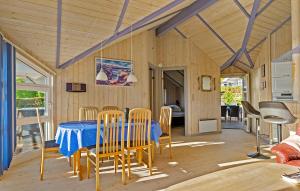 a dining room with a table and chairs at Holiday Home Hvedemarken in Hejls
