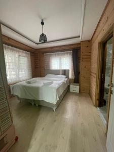 a bedroom with a bed in a room with windows at Su Apart in Rize
