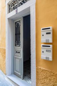 a doorway to a building with a white door at Venetian Alley Studio in Corfu Town +15 photos