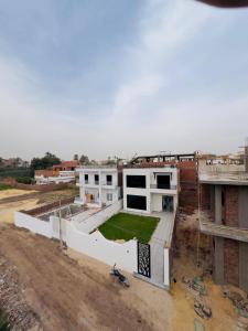 a building under construction with a field on the roof at Villa Kayan in Luxor