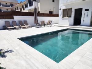 a swimming pool in the middle of a house at Yama's Villa - Polyxenia luxury, protaras, cyprus in Protaras