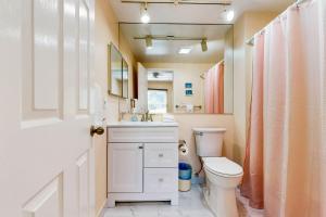 a bathroom with a toilet and a sink and a mirror at Sea Colony --- 16004 Bayberry Court in Bethany Beach +10 photos