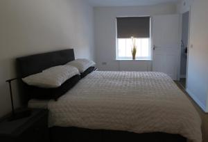 a bedroom with a large bed with a window at Hillwood Court By Horizon Stays in Thornaby on Tees