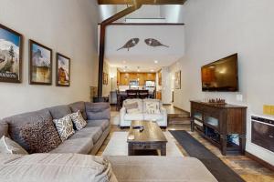 a living room with a couch and a tv at St. Moritz 13 in Mammoth Lakes