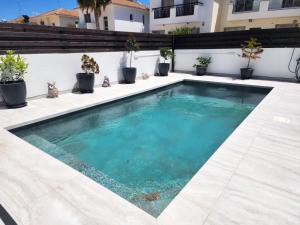 a swimming pool on the side of a building at Yama's Villa - Polyxenia luxury, protaras, cyprus in Protaras