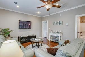 a living room with a couch and a ceiling fan at Happy Place by Bolivar Escapes in Crystal Beach