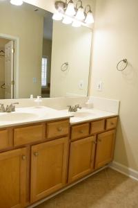a bathroom with two sinks and a large mirror at Marietta Hideaway in Marietta