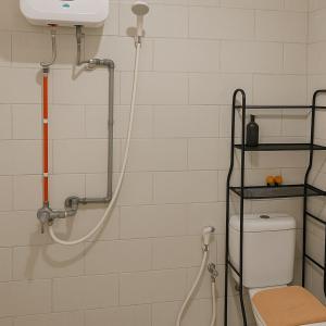 a shower in a bathroom with a toilet at LuxBedAndersonPakuwon by BnB in Surabaya