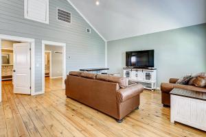 a living room with a couch and a flat screen tv at Sea You Soon in Port Bolivar