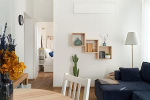 a living room with a blue couch and a table at La Maison Blue, between Portello-Fiera-MiCo-CityLife in Milan +12 photos