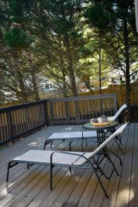 a patio with a table and chairs on a deck at Marietta Hideaway in Marietta