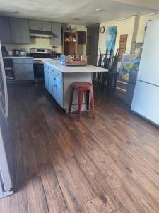 a kitchen with a counter and a table with a stool at Orange County Homes in Santa Ana +11 photos