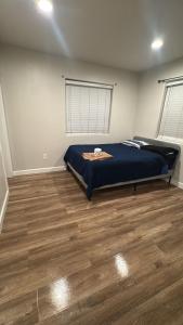a bedroom with a bed and a wooden floor at Orange County Homes in Santa Ana