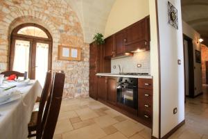 A kitchen or kitchenette at trullo degli ulivi con piscina e vasca per bambini