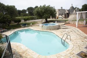 The swimming pool at or close to trullo degli ulivi con piscina e vasca per bambini