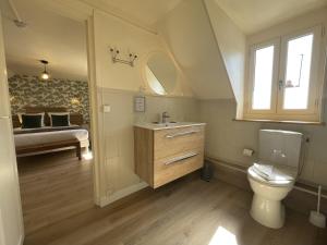 a bathroom with a toilet and a sink and a bed at Le Trouville - Hôtel de Charme in Trouville-sur-Mer +70 photos