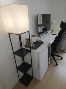 an office with a desk with a lamp on it at Chambres près des 24H avec 1 lit et 1 lit d'appoint -60kg in Le Mans