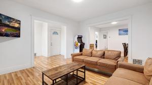 a living room with a couch and a table at 6 bedroom House Short Walk to Niagara Falls in Niagara Falls