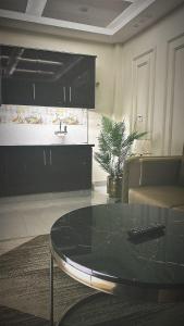 a living room with a glass table and a couch at Apartment in Bahria Town Lahore in Lahore