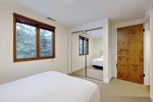 a bedroom with a bed and a door with a mirror at Sun Valley Alpenglow in Ketchum