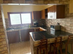 a kitchen with a counter and a stove top oven at Ouest foire in Dakan