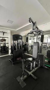 a room with a gym with a treadmill and weights at Lindo apartamento 50 metros da praia in Cabedelo