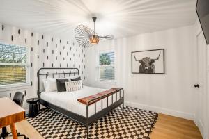 a bedroom with a bed and a cow on the wall at Fun-Filled Backyard Firepit Grill Games Good Vibes in Houston +42 photos