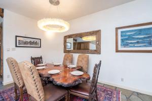a dining room with a table and chairs and a mirror at Rivercrown 7 by Exceptional Stays in Telluride +10 photos