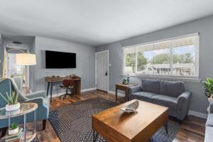 a living room with a couch and a table at 3 Bedroom House with Firepit St. Peters, MO in Saint Peters