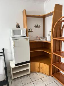 a kitchen with a microwave on top of a refrigerator at Monteurzimmer mit Küchennutzung in Bad Essen